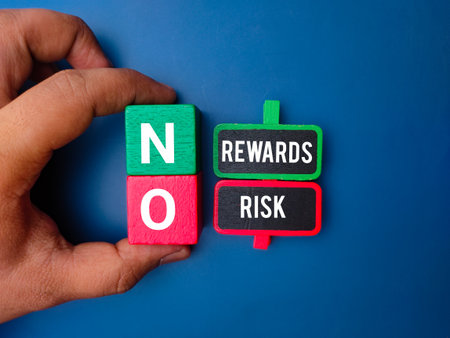 Hand holding colored cube with the word NO REWARDS RISK on blue background.の写真素材