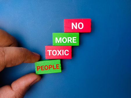 Hand holding colored wooden block with the word NO MORE TOXIC PEOPLE.の写真素材