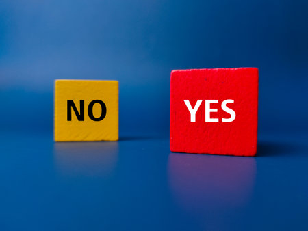 Colored cube with the word NO YES on a blue background. Business concept.の写真素材