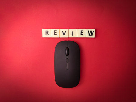 Toys word and wireless mouse with the word REVIEW on red background.Business concept.の写真素材