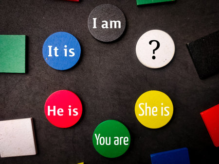 Colored wooden with word I am,It is,He is,You are and She is on black background.の写真素材