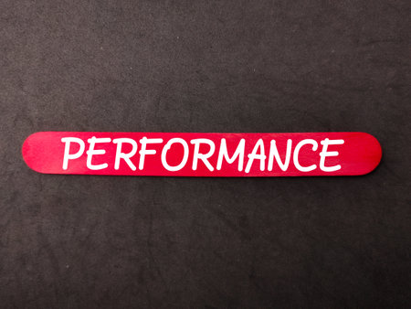Colored wooden stick with the word PERFORMANCE on black background. Business concept.の写真素材