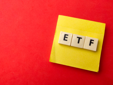 Toys word and sticky note with word ETF on red background. Business concept.の写真素材