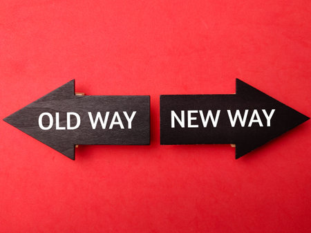 Wooden arrow with the word OLD WAY NEW WAY on a red background