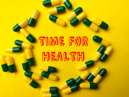 Pills with the word TIME TO HEALTH on a yellow background.の写真素材