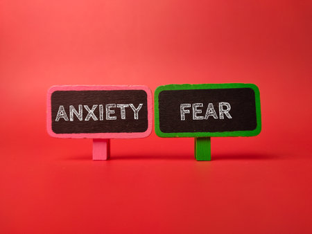 Colored sign board with the word ANXIETY FEAR  on red backgroundの写真素材