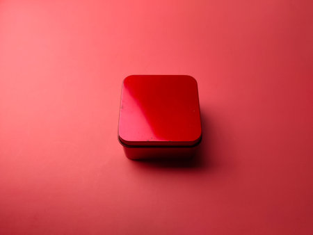 Closeup red aluminium box on a red backgroundの写真素材