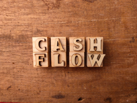 Wooden letters arranged into the word CASH FLOW on a wooden backgroundの写真素材