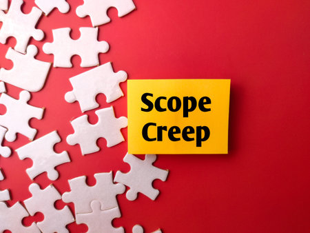 Sticky notes and white puzzle with the word Scope creep on a red background