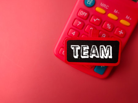 Calculator and wooden board with word TEAMの写真素材