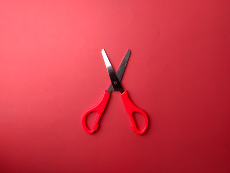 Top view red scissors on a red backgroundの写真素材