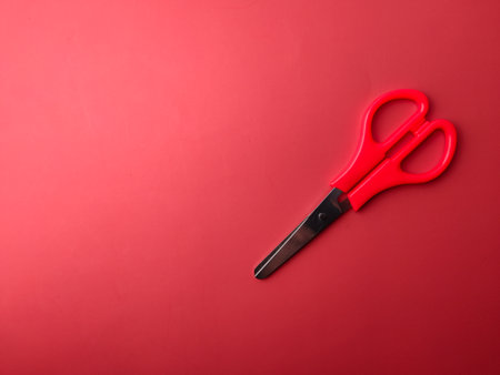 Top view red scissors on a red background with copy spaceの写真素材