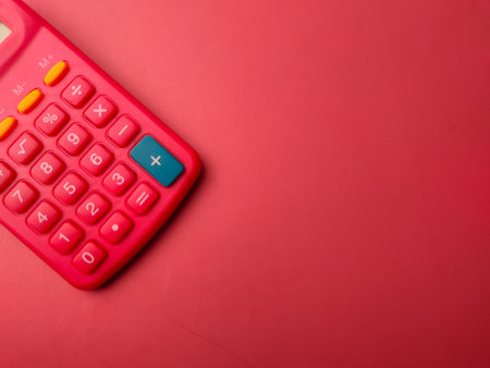 Top view red calculator on a red background with copy spaceの写真素材