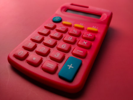 Closeup red calculator on a red backgroundの写真素材