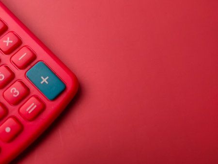 Top view red calculator on a red background with copy spaceの写真素材