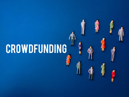 Miniature people with the word CROWDFUNDING on a blue background. Crowdfunding concept.の写真素材