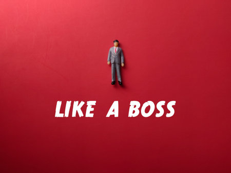 Miniature people with the word LIKE A BOSS on a red background