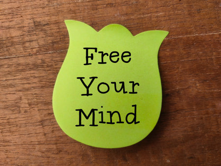 Colored sticky note with the word FIND YOUR MIND on a wooden backgroundの写真素材