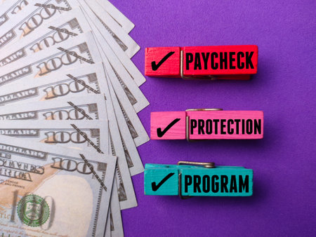 Banknotes with the word PAYCHECK PROTECTION PROGRAM on a purple backgroundの写真素材