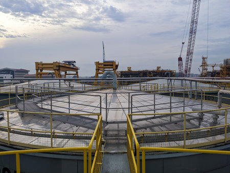 The view from the top of the storage tank for cooking oil and crude palm oil with sky background.