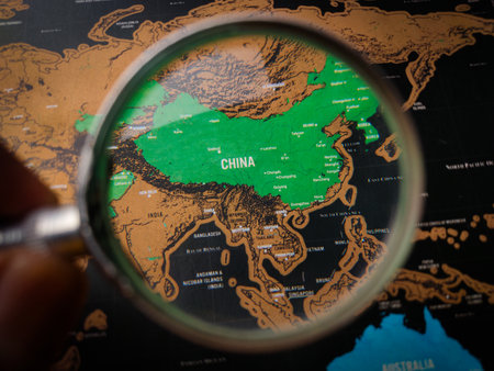 Top view hand holding magnifying glass and focus to CHINA mapの写真素材