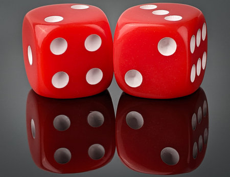 Closeup two red dice with reflection on black acrylic board