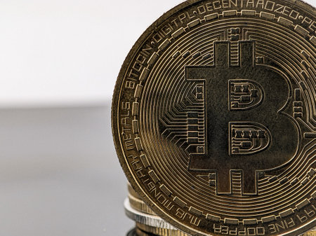 Closeup gold bitcoin on a black acrylic board with copy spaceの写真素材