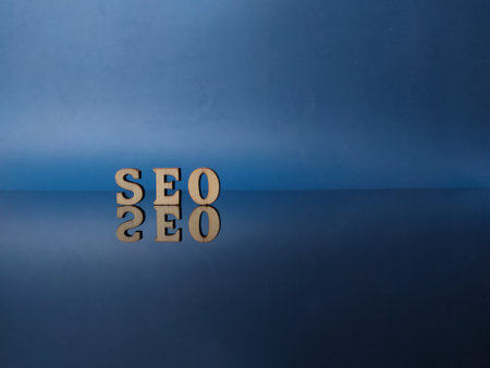 Wooden word with word SEO on a black acrylic board with reflection and copy spaceの写真素材