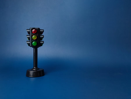 Mini traffic lights traffic lights toy on a blue background with copy and text space.の写真素材