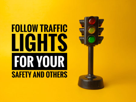 Traffic light with text FOLLOW TRAFFIC LIGHTS FOR YOUR SAFETY AND OTHERS on a yellow background
