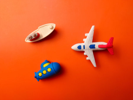 Top view toy ship,submarine and air plane on an orange background
