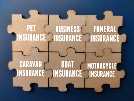 Top view wooden puzzle with insurance concept on a blue background. Business and insurance concept.の写真素材