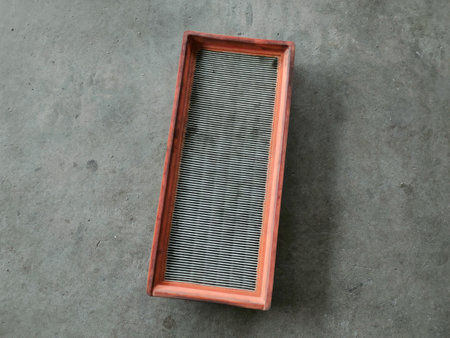 A car air filter placed on the floor of a workshop.の写真素材