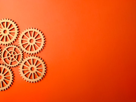 Top view of wooden gear on an orange background with copy space.の写真素材