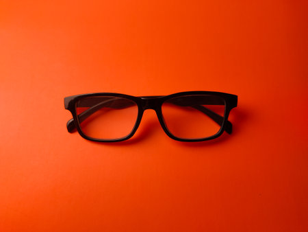 Top view black glasses on an orange background.の写真素材