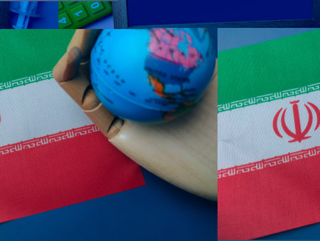 Wooden hand holding globe with Iran flag on a blue background.の写真素材