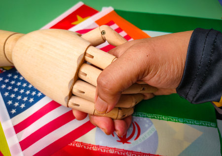 Hand shaking on a variety of flags in each country.の写真素材