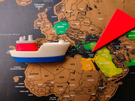 The image shows a map of Europe and the Middle East, with a toy ship and a red arrow placed on it.
