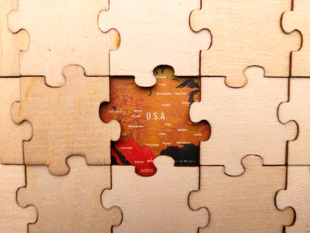 The image shows a wooden jigsaw puzzle with a section of a map of USA visible.