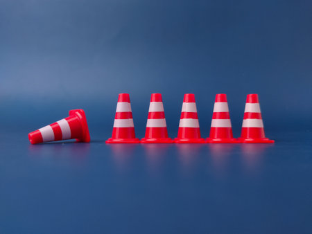 The image shows several miniature traffic cones, with one lying on its side.の写真素材