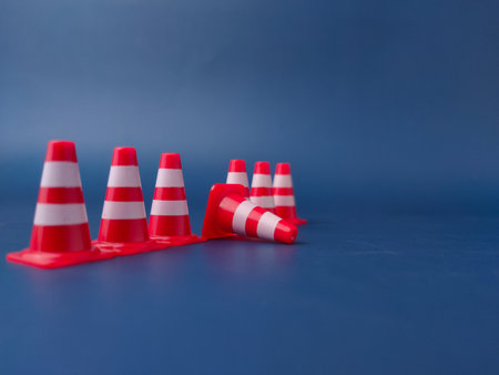 The image shows several miniature traffic cones, with one lying on its side.の写真素材