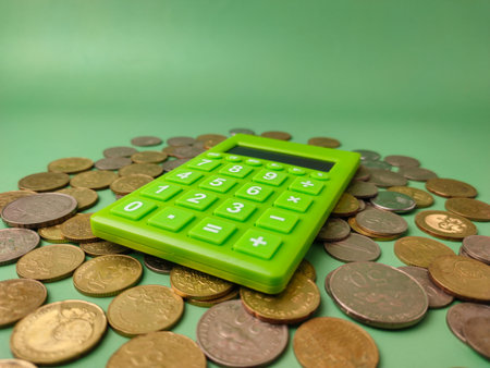 The combination of a calculator and money symbolizes financial management, savings, or investment.の写真素材