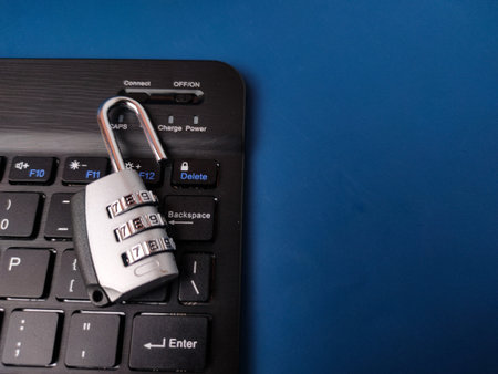 The image displays combination padlockÂ resting on a computer keyboard, symbolizing digital...