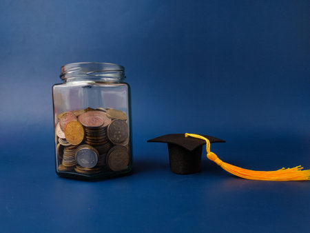 The image is a stock photo symbolizing the concept of saving money for education.の写真素材