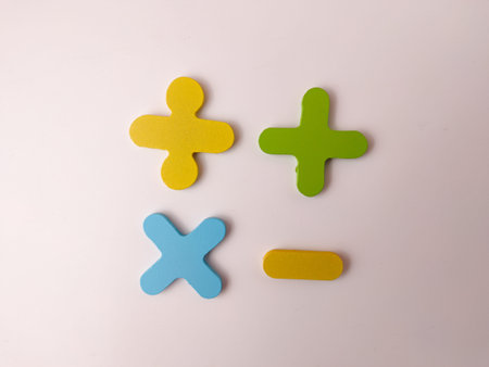 The image displays wooden or foam cutouts of basic mathematical operation symbols.