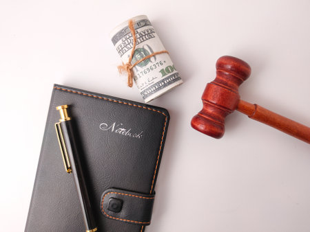 The image is a stock photo that combines objects often associated with law, finance, or auctions to represent a concept.の写真素材