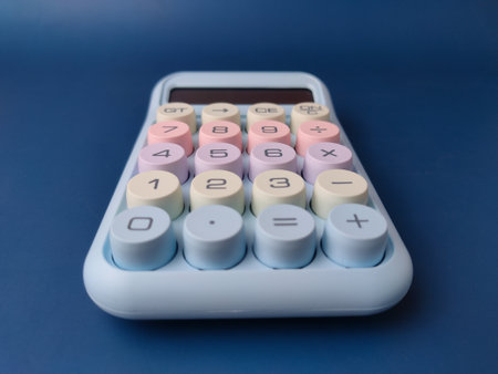 Top view pastel-colored desktop calculator featuring a retro typewriter style with large, round mechanical keys.の写真素材