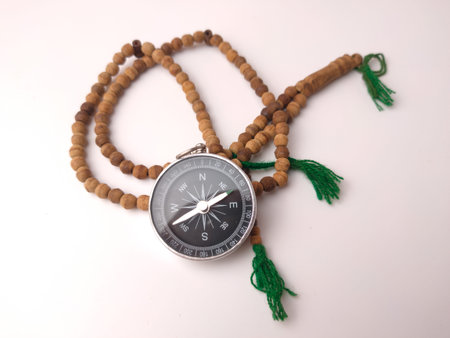 CompassÂ paired with a set of prayer beads tasbih.