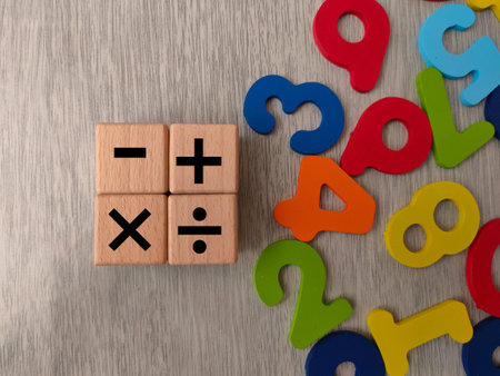 The image displays wooden cubes with basic mathematical operation symbols.