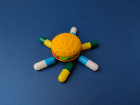 Surrounding the burger are several large, colorful capsules in various combinations.
